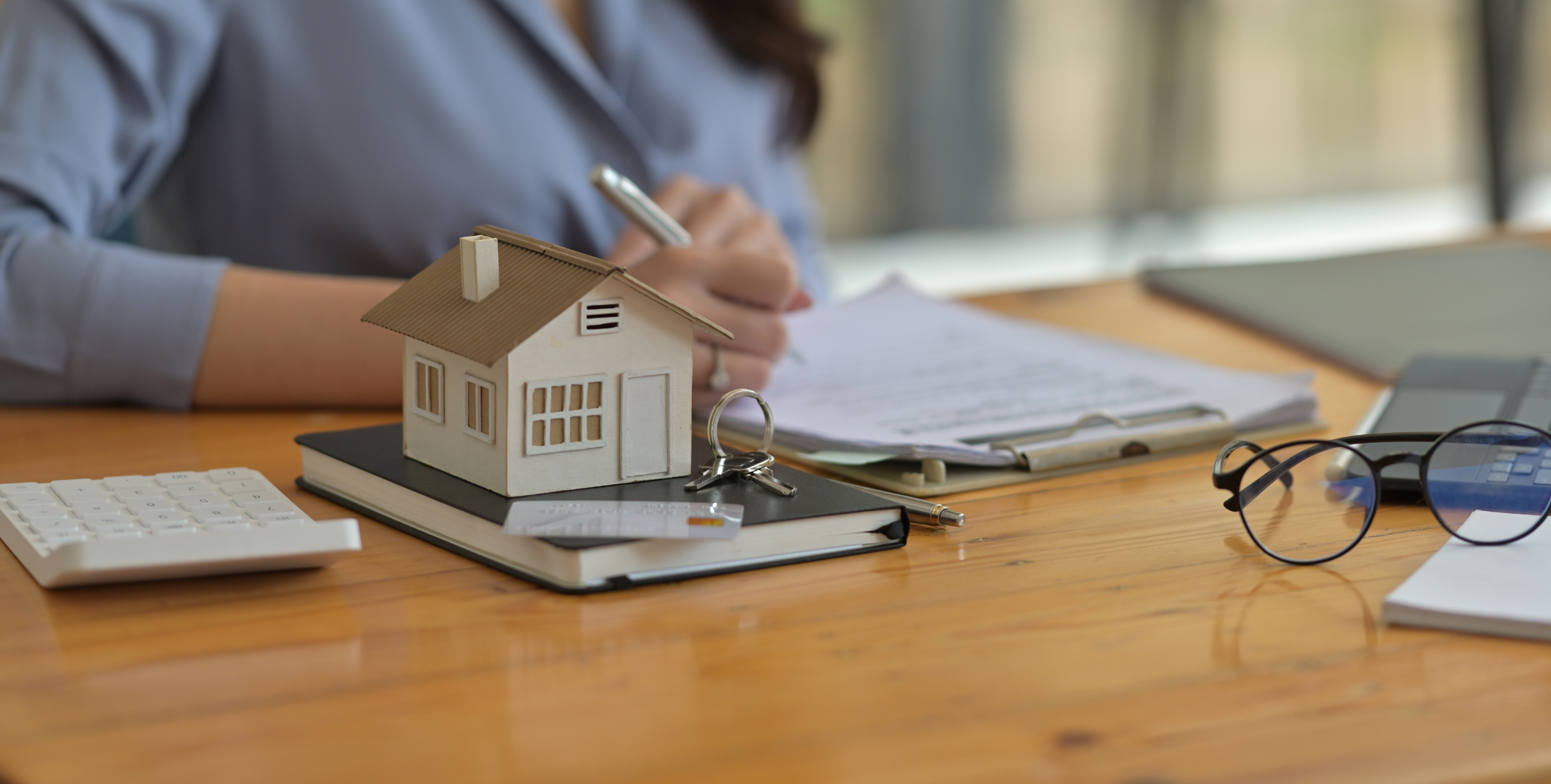 Lease agreement and house model symbolizing legal steps for landlords