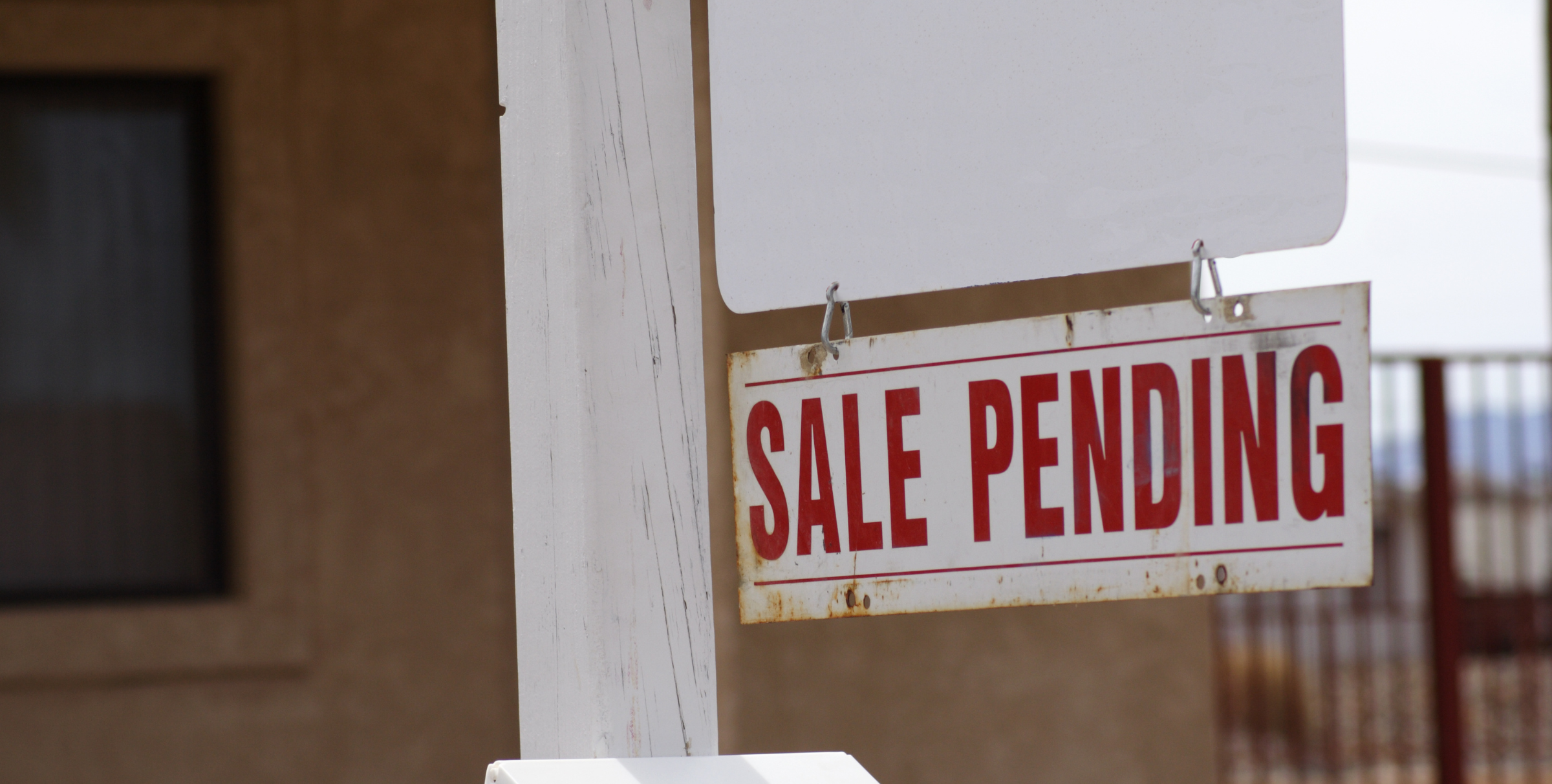 Sale Pending sign outside a Chicago residential home, representing a real estate deal in progress or at risk of falling through.